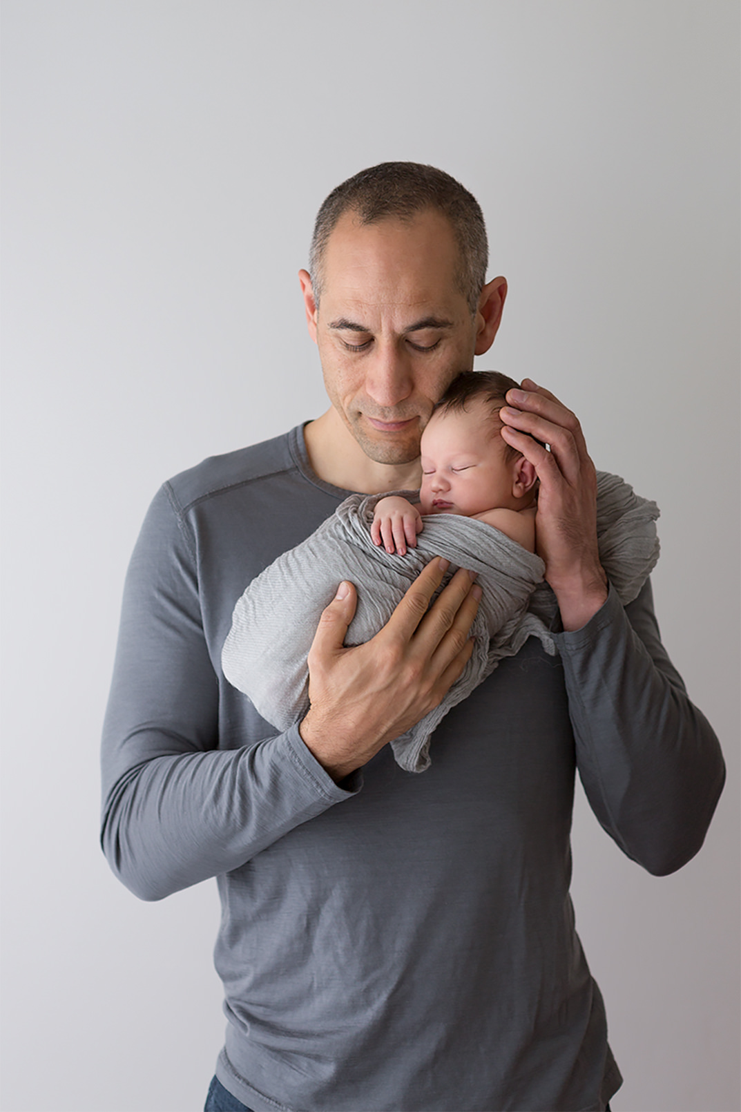 Newborn snuggles with Dad
