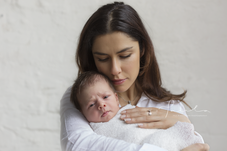 Mother nuzzling newborn son