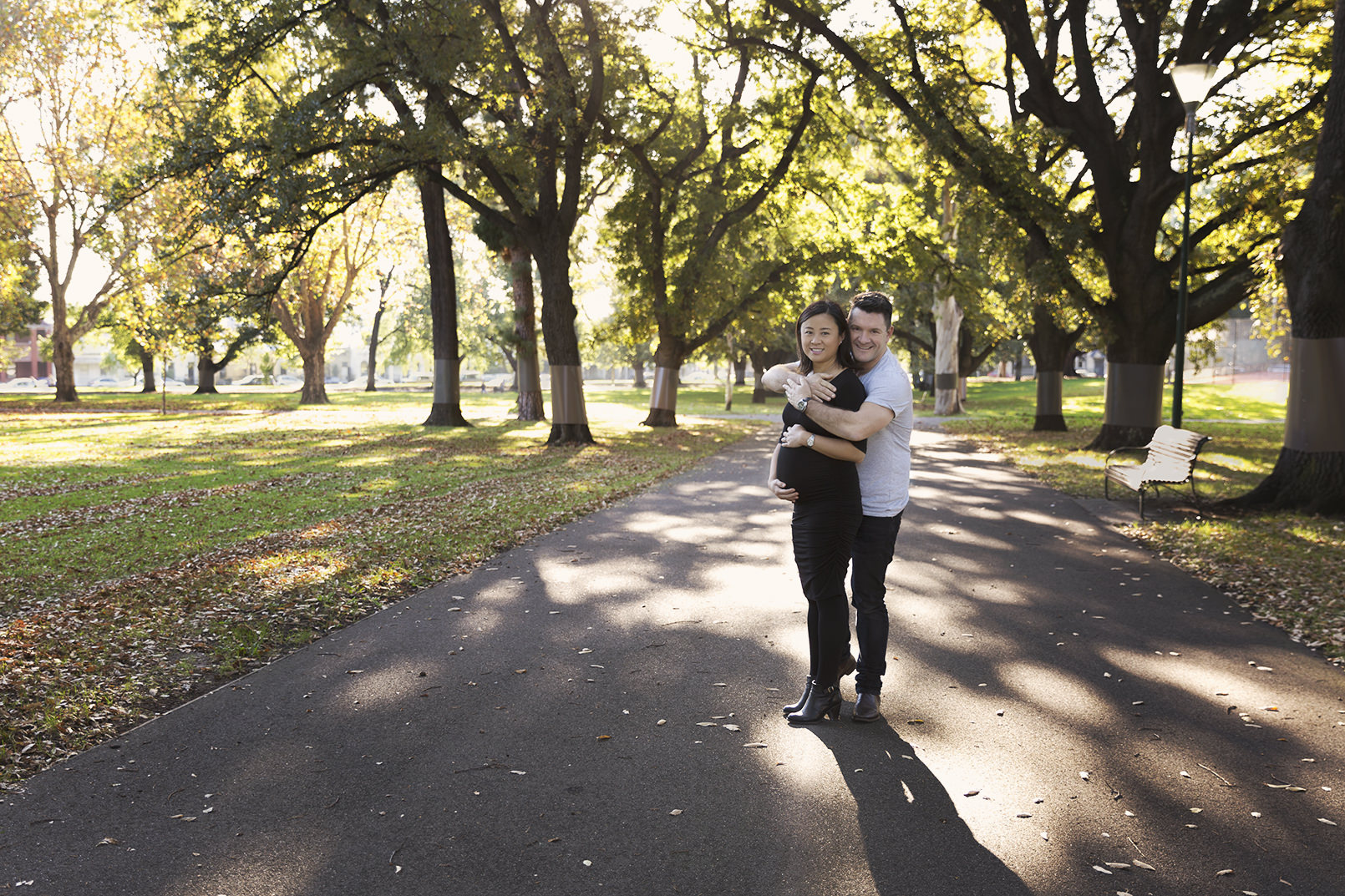 Pregnant mother and father in Carlton Gardens, Melbourne