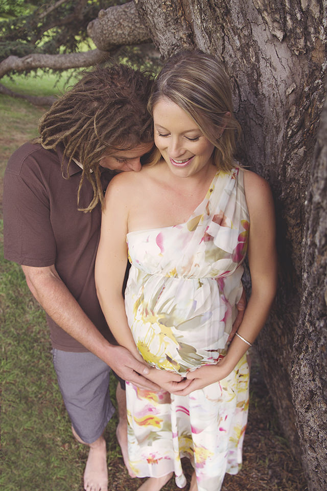 Pregnant lady being kissed by father to be