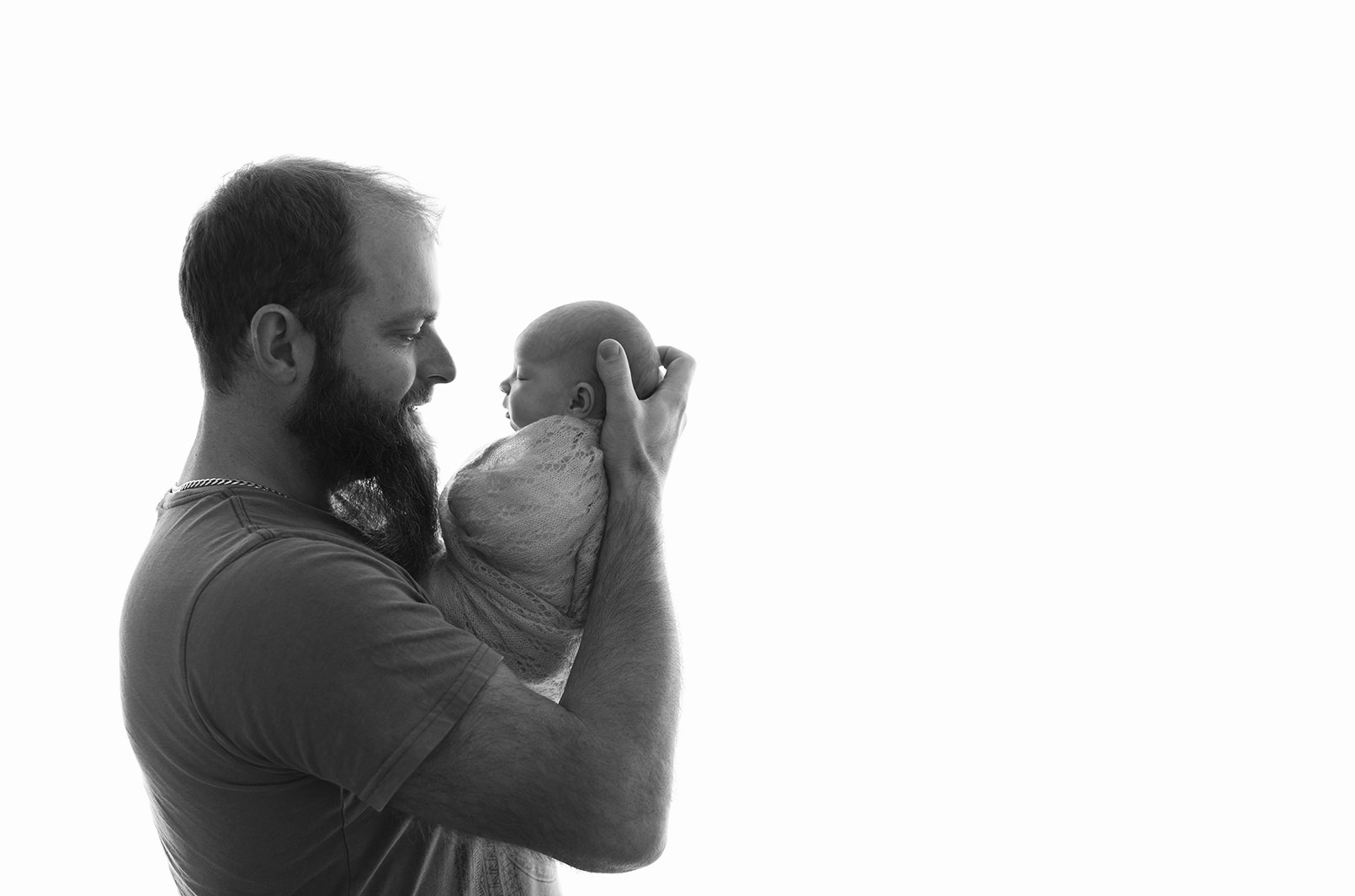 Bearded Dad holding new baby son