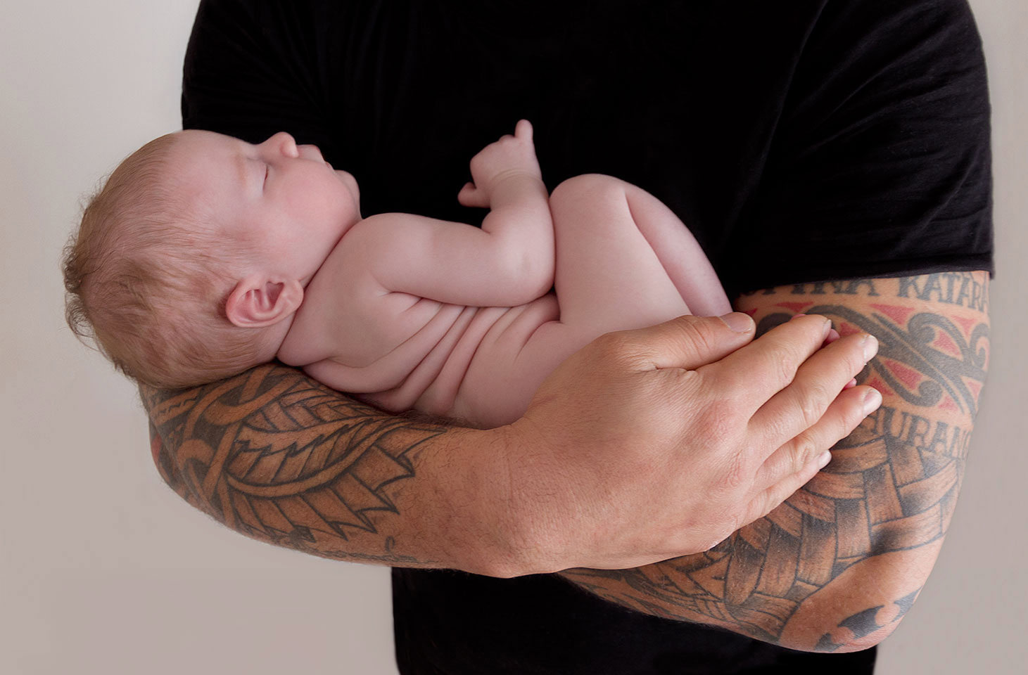 Tattooed Dad hugging his baby girl