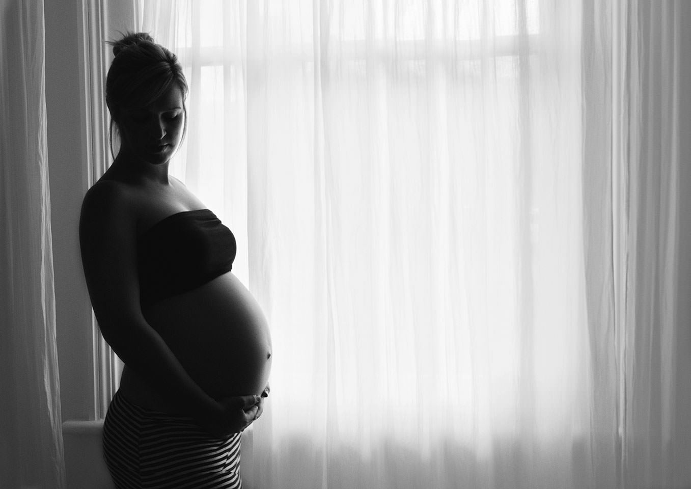 Baby bump in front of window