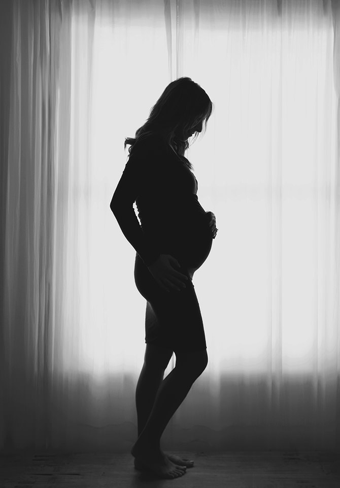 Silhouette of mother in third trimester of pregnancy