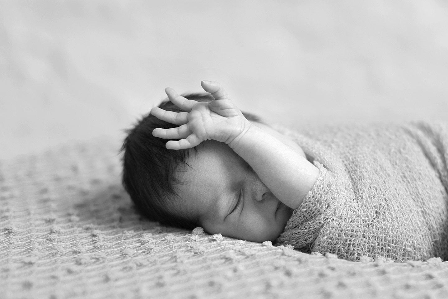 Stretching newborn baby girl