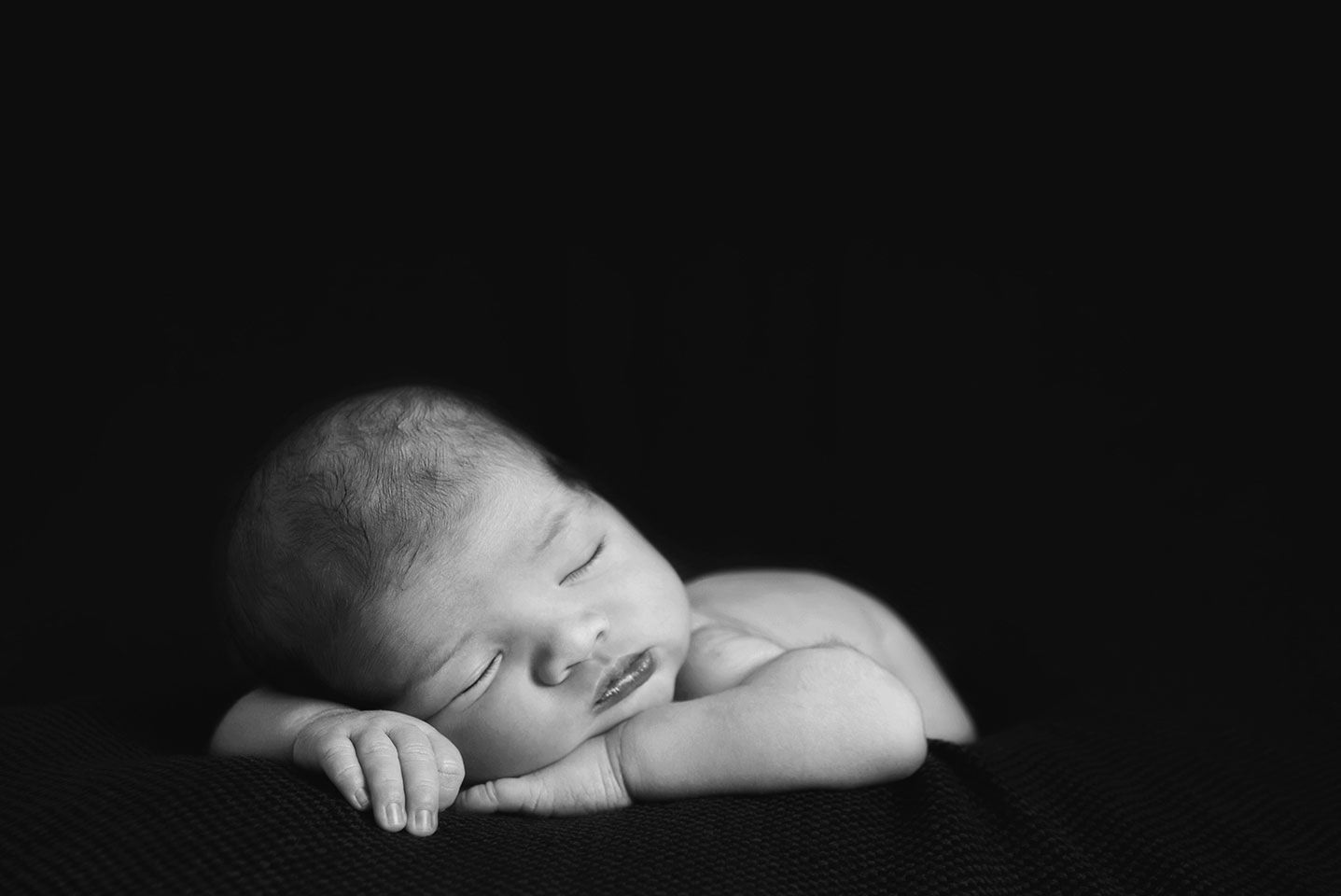 black and white portrait of sleeping newborn baby