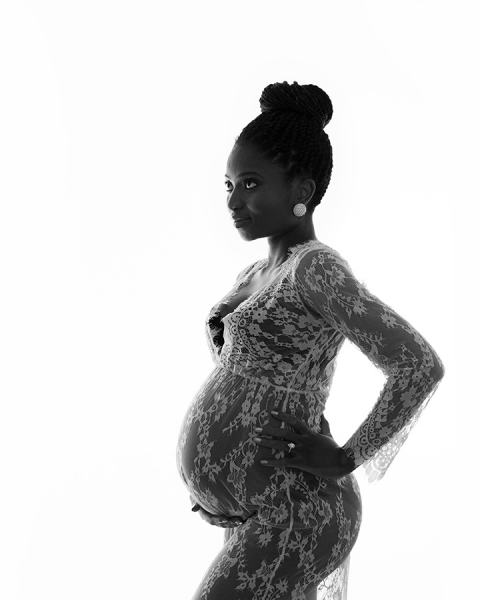 African lady in white lace maternity gown