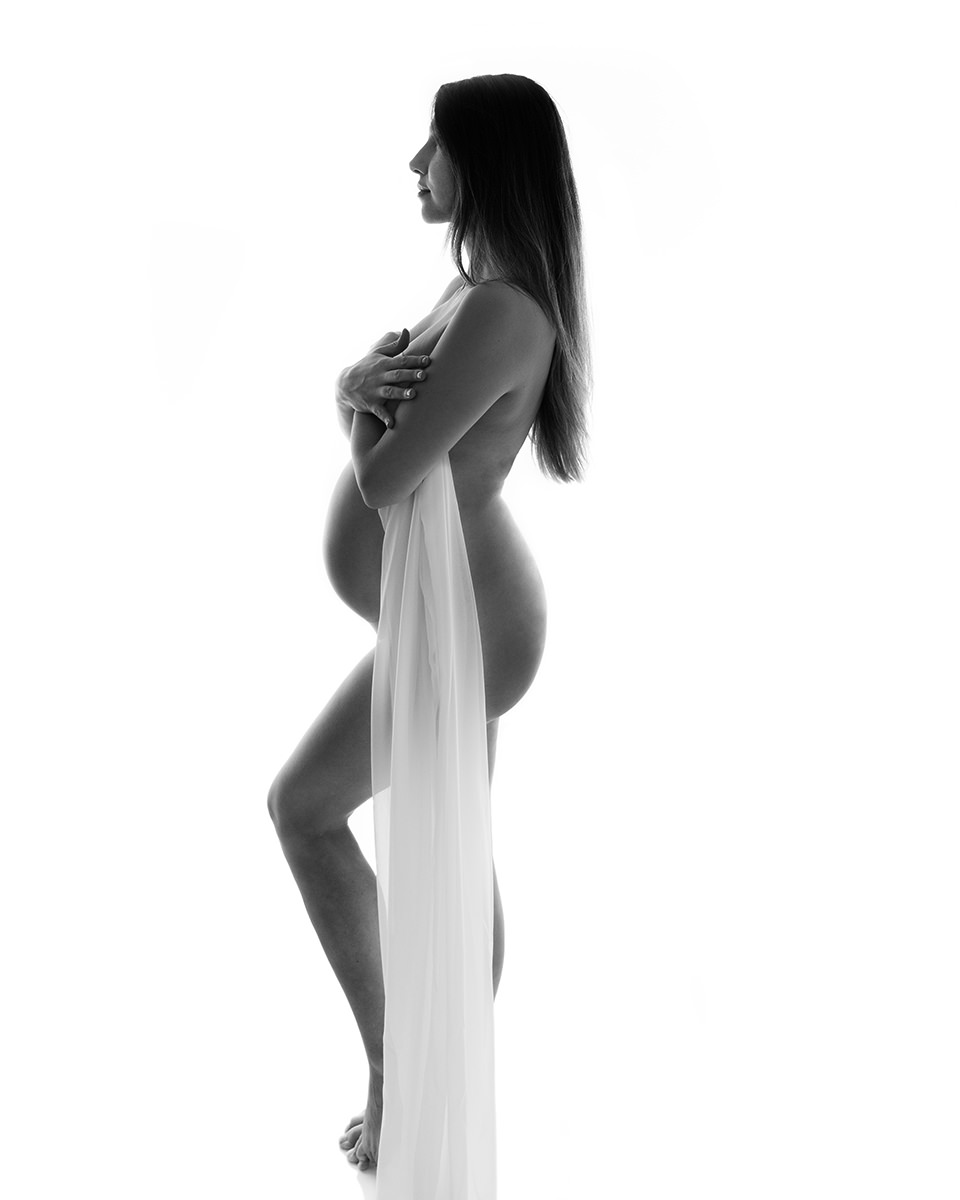 Portrait of pregnant lady draped in fabric at maternity photoshoot